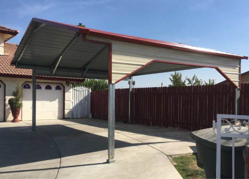 A-frame horizontal steel carport with a beige gabled roof, red trim, and open sides installed over a concrete residential driveway.